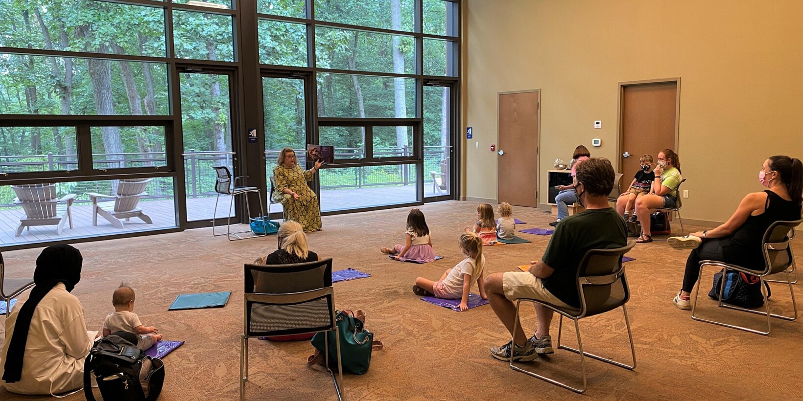 Children and caretakers listening to Storytime at Jenkins Arboretum.