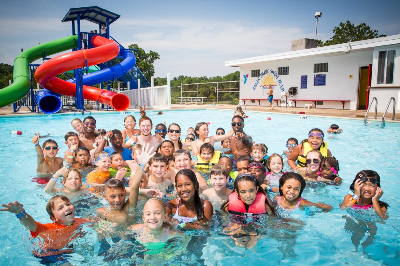 A big, diverse group of kids in a community pool