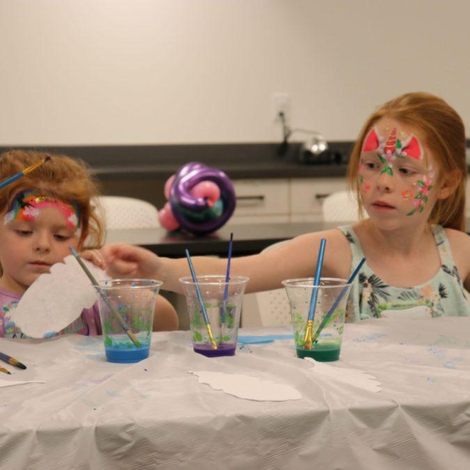 female children painting at a table