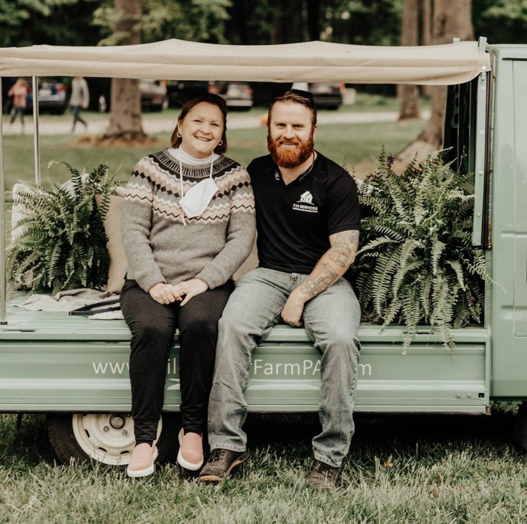 PJA Service, Pete Achuff and his mom sitting on a truck bed.