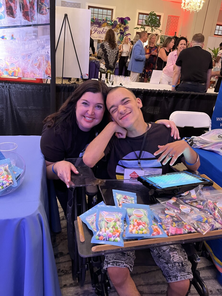 Aimee Rubin, owner of Game on State arcade, poses with an employee with disabilities.