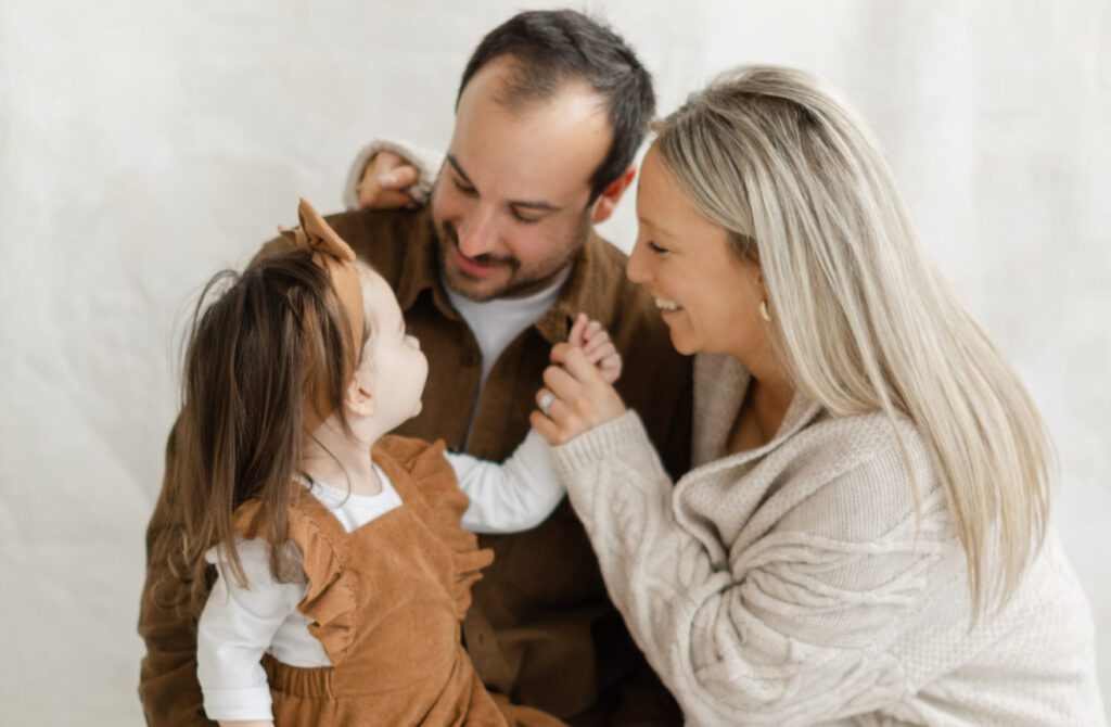 Caucasian family photo shoot, mom, dad, toddler girl.