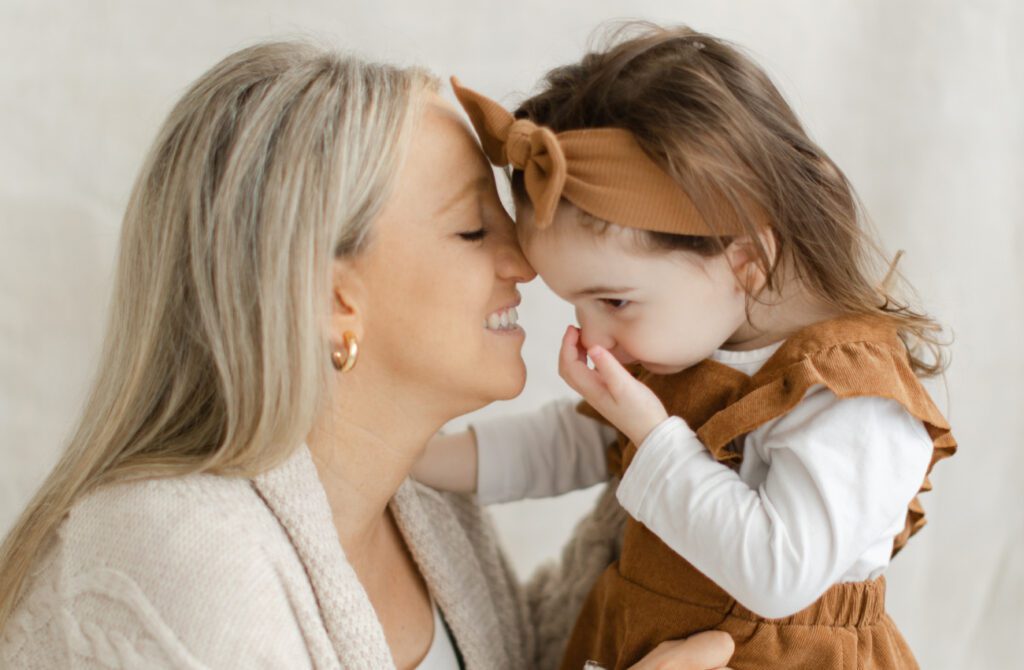 Caucasian mother and toddler daughter sharing a special moment during a photoshoot