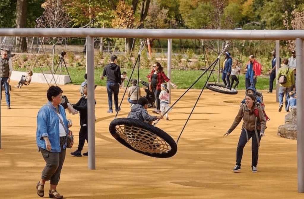 Mom pushes her young child on a swing at Anna C. Vera, an all abilities playground in FDR Park in Philadelphia.