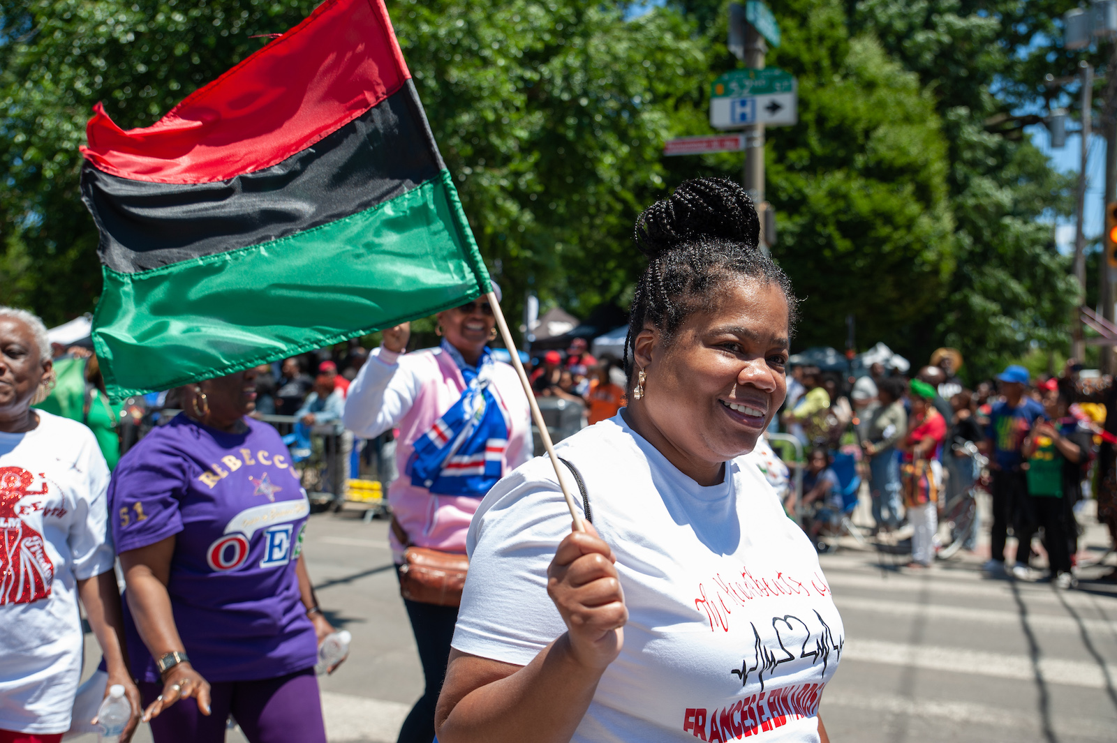 A Juneteenth parade with a woman waving a flag