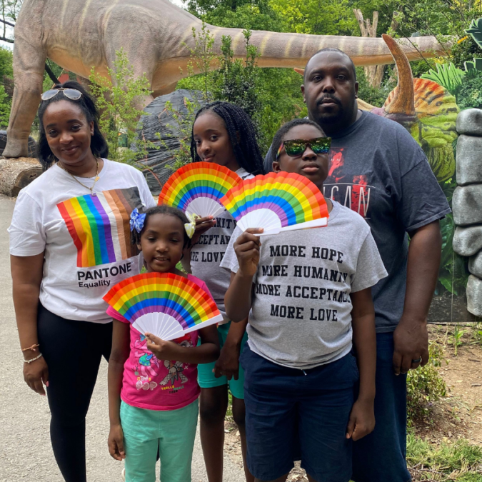 A family of 5 demonstrates Pride support with rainbow t-shirt and fans at the Philadelphia Zoo Pride Day.