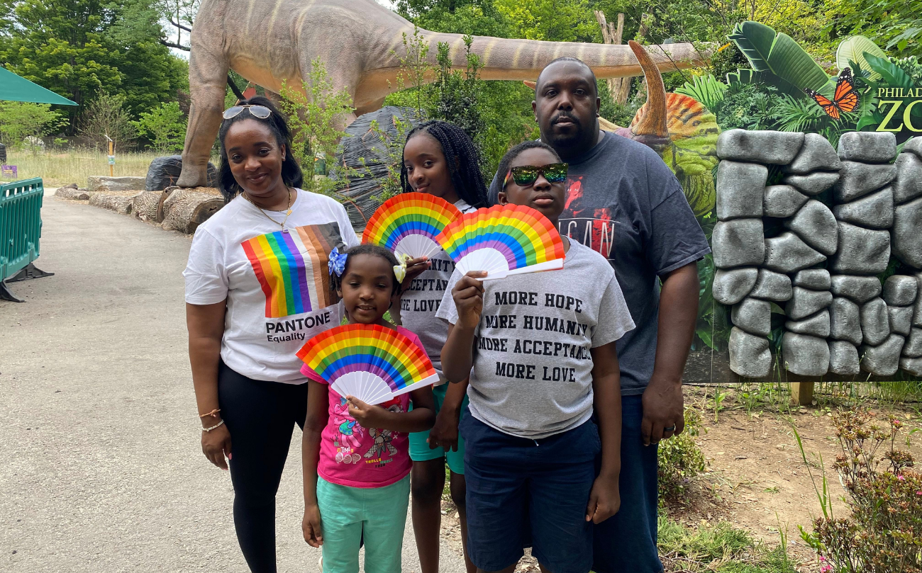 A family of 5 demonstrates Pride support with rainbow t-shirt and fans at the Philadelphia Zoo Pride Day.