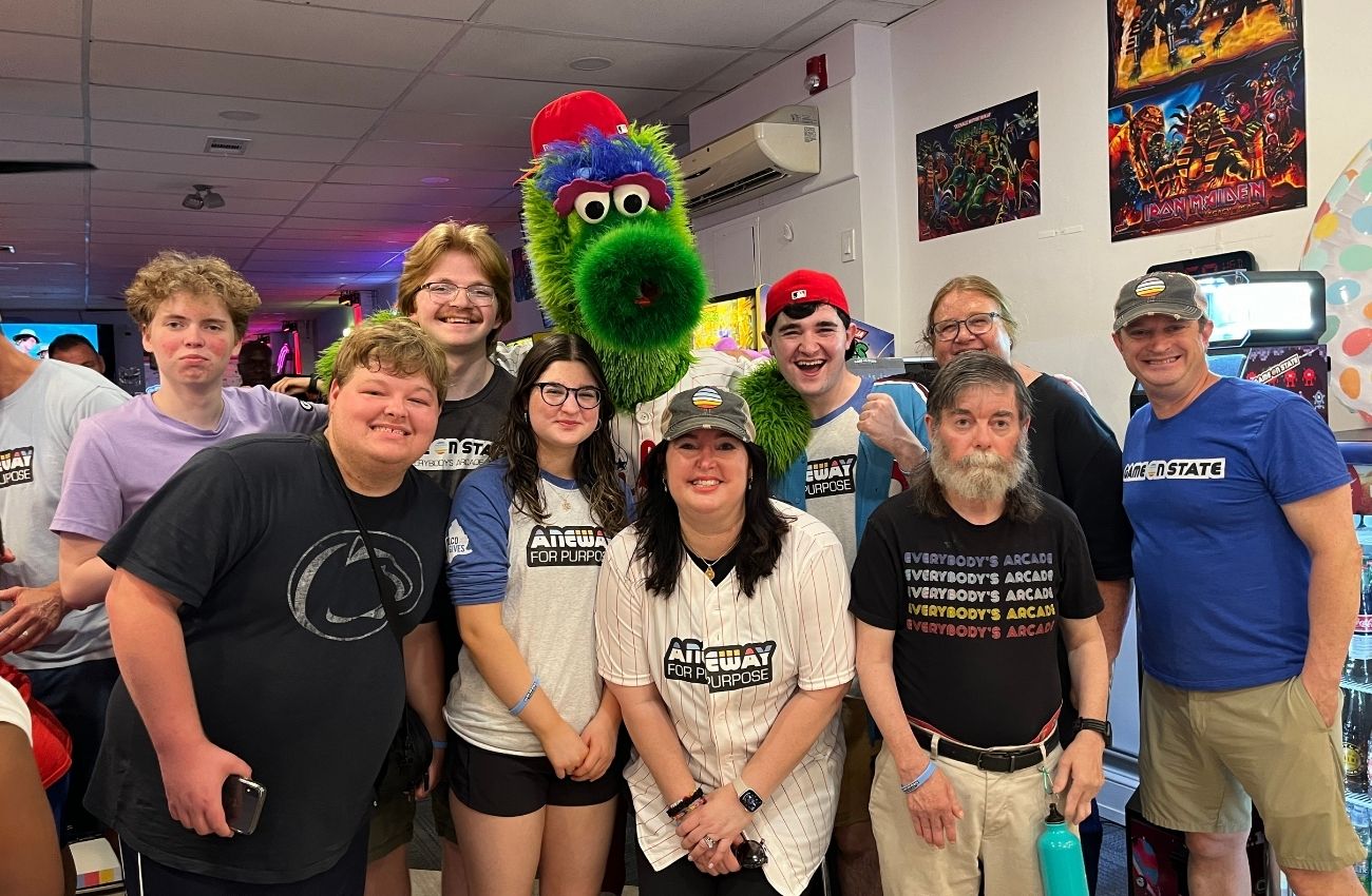 Aimee Rubin and the staff at Game on State pose with the Philly Phanatic.