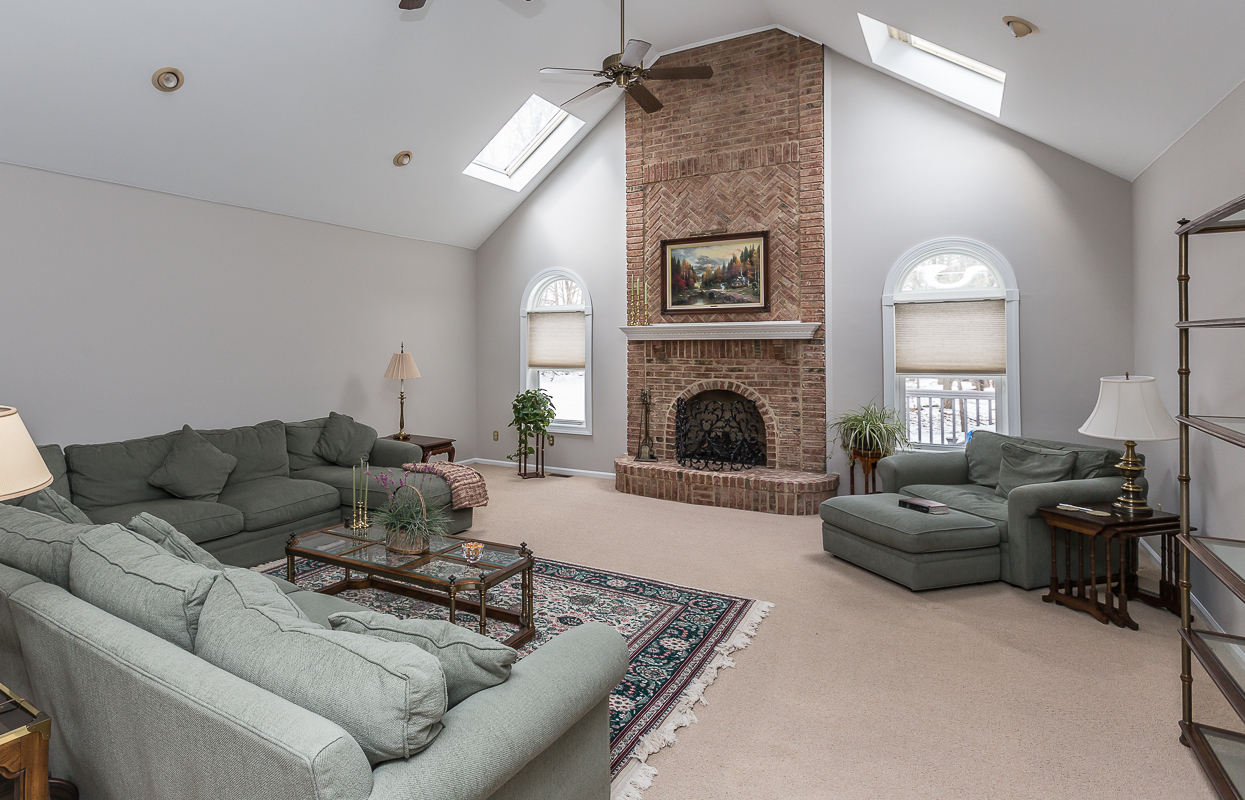Family room renovation and painting project, brick fireplace and sectional sofa.