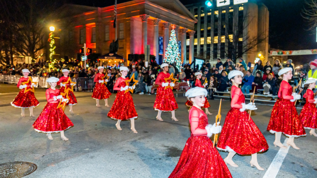 Young girls dressed in holiday red dance in the West Chester Parade after the tree lighting.