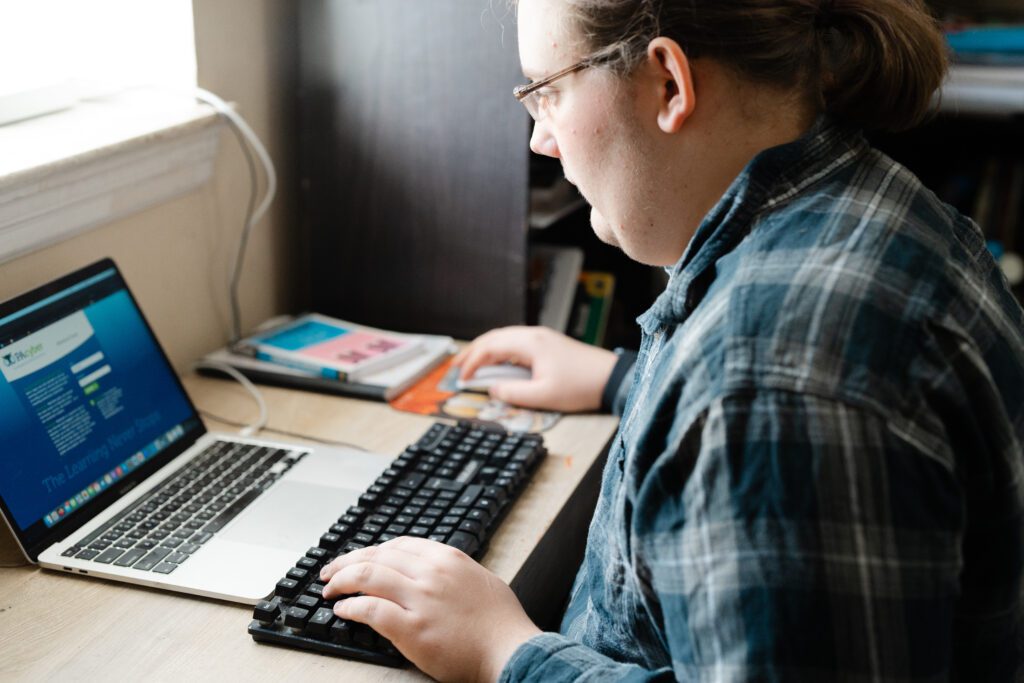 Cyber school student working from a laptop at his desk