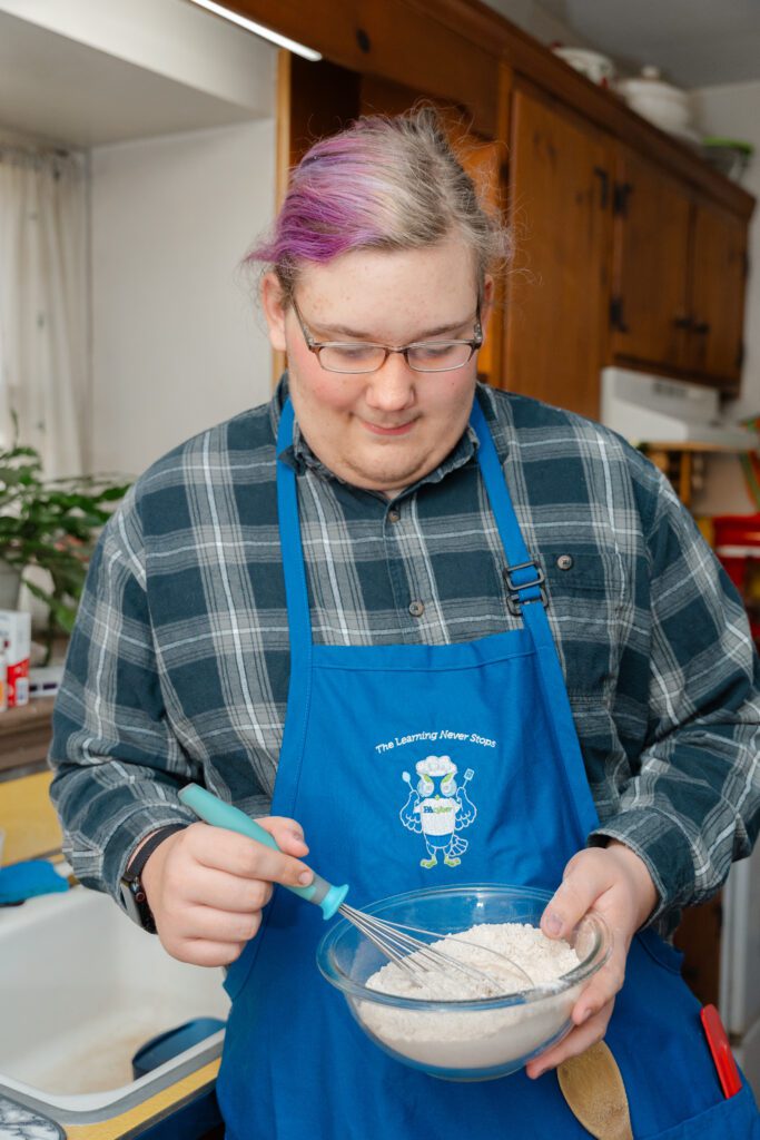 male teenager mixing a cake