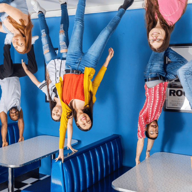 It looks like people are standing on the ceiling at the Museum of Illusions, a unique museum.