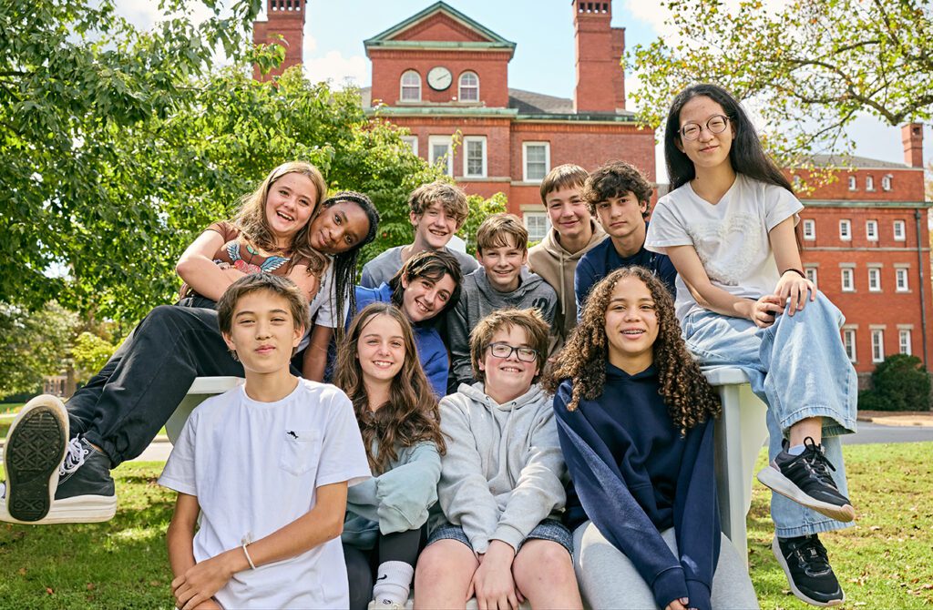 Group of middle school students hanging out on campus.