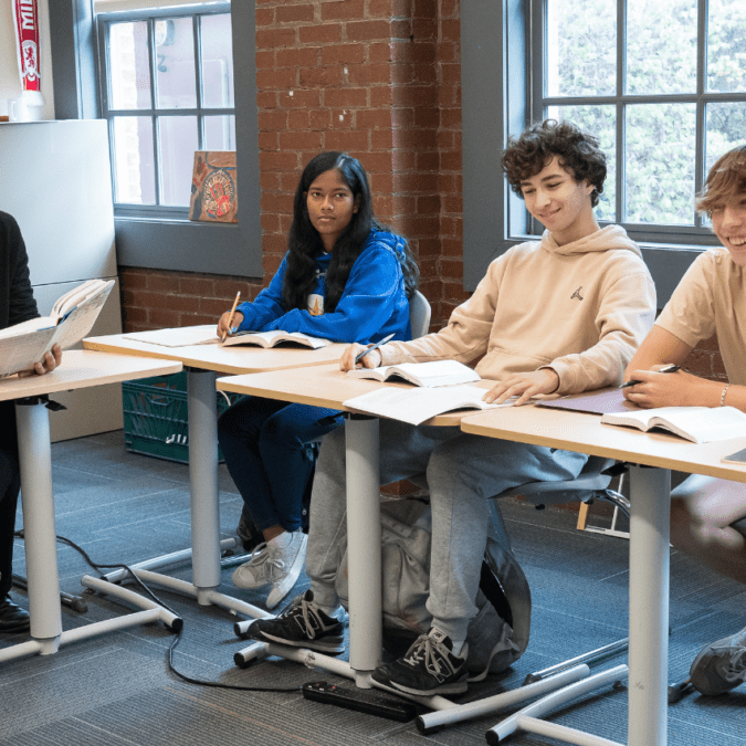 AIM Academy emphasizes college readiness. High school students' desks are arranged like a college classroom.