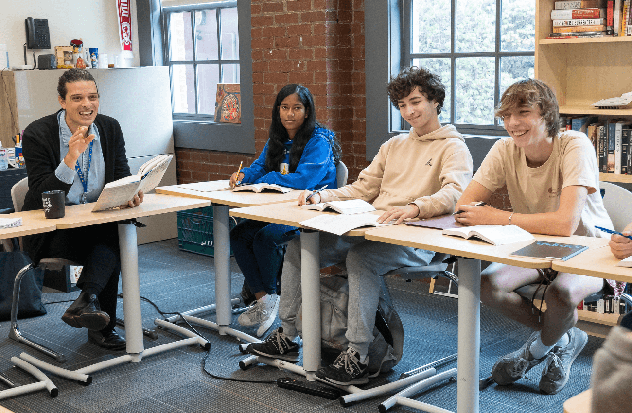 AIM Academy emphasizes college readiness. High school students' desks are arranged like a college classroom.