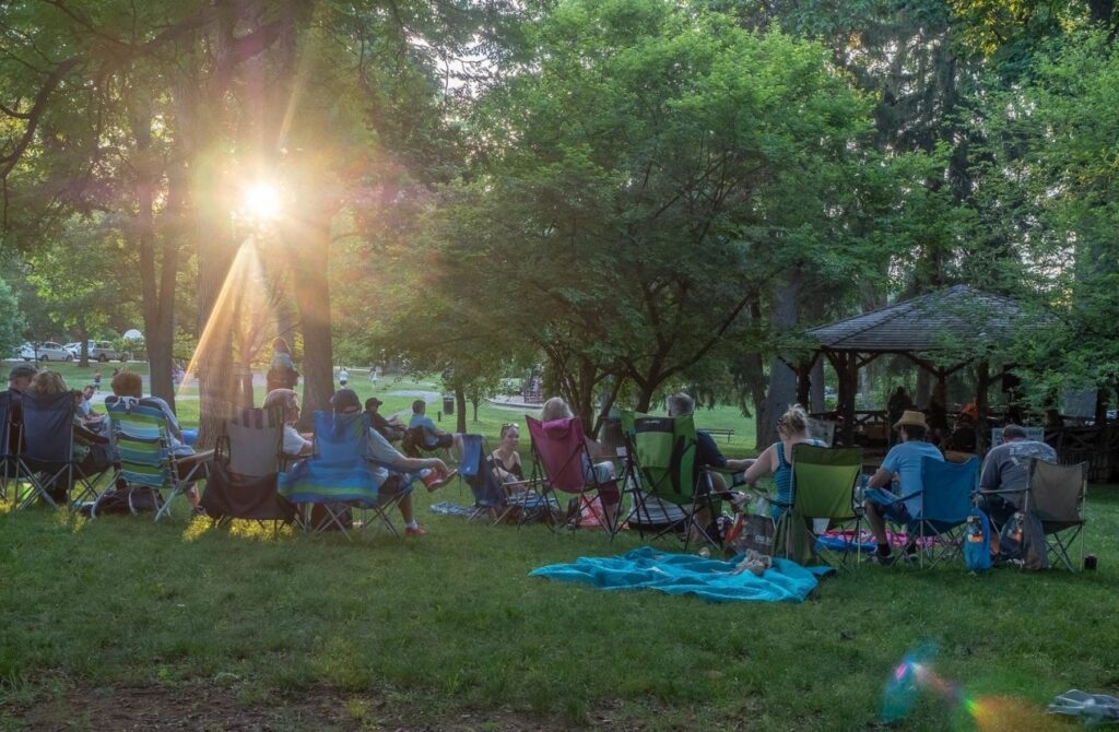 Folks relax on the lawn at Marshall Square Park in West Chester for an outdoor concert.