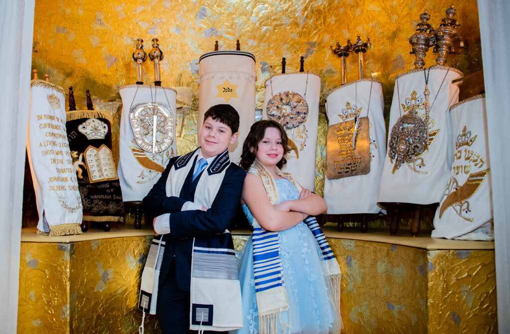 boy and girl in front of the Torah at a synagogue