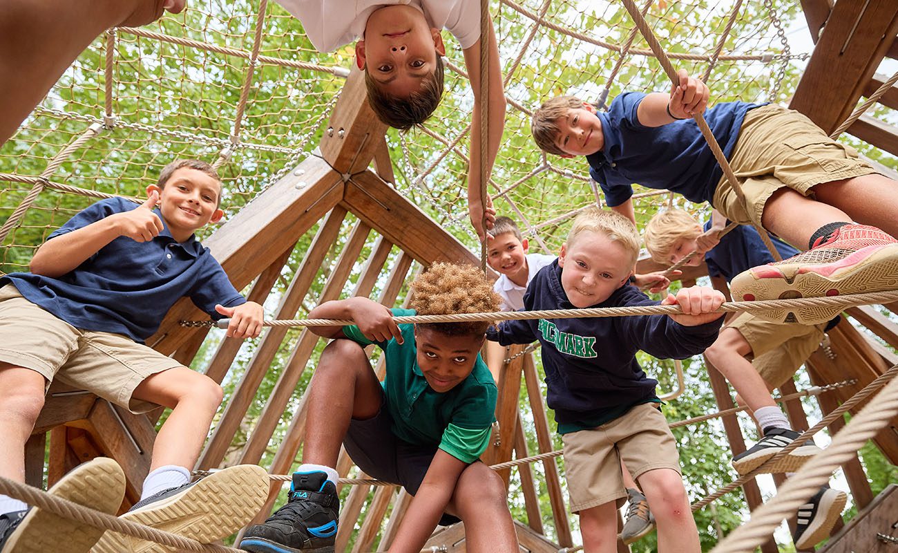 elementary students on a climbing structure
