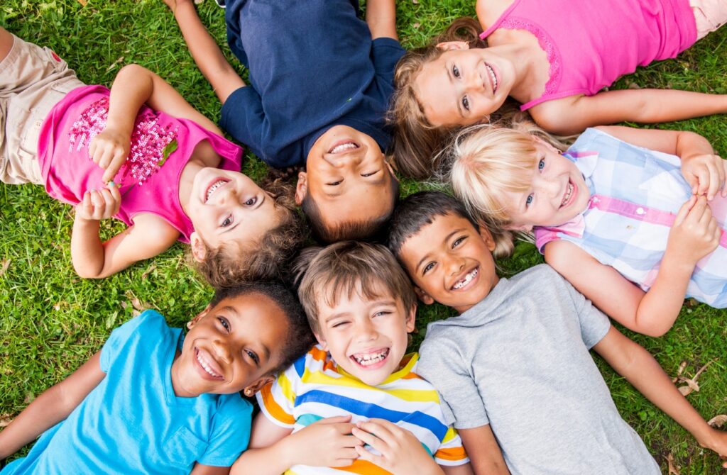 Young campers posting with their heads together in the grass at ESF Camps