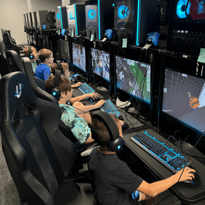 Boys playing video games as part of a STEM-Accredited Gaming Program at Uplink summer camp.