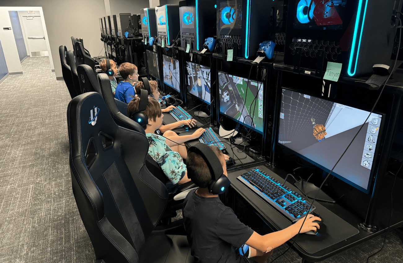 Boys playing video games as part of a STEM-Accredited Gaming Program at Uplink summer camp.
