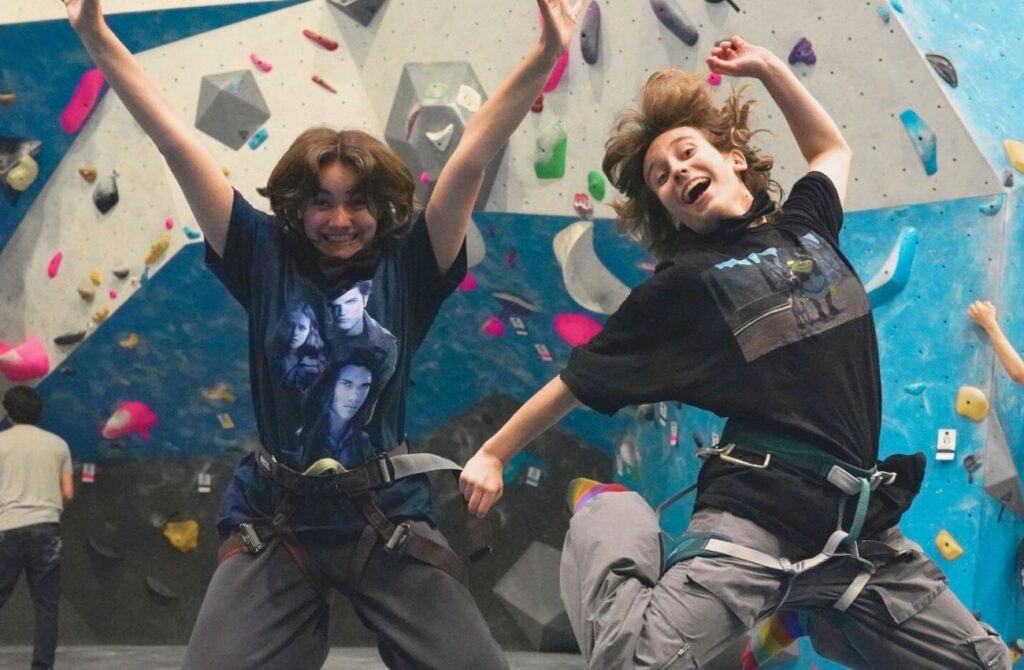 Two teens jump with joy at Gravity Vault in Radnor, a fun Main LIne activity for teens.