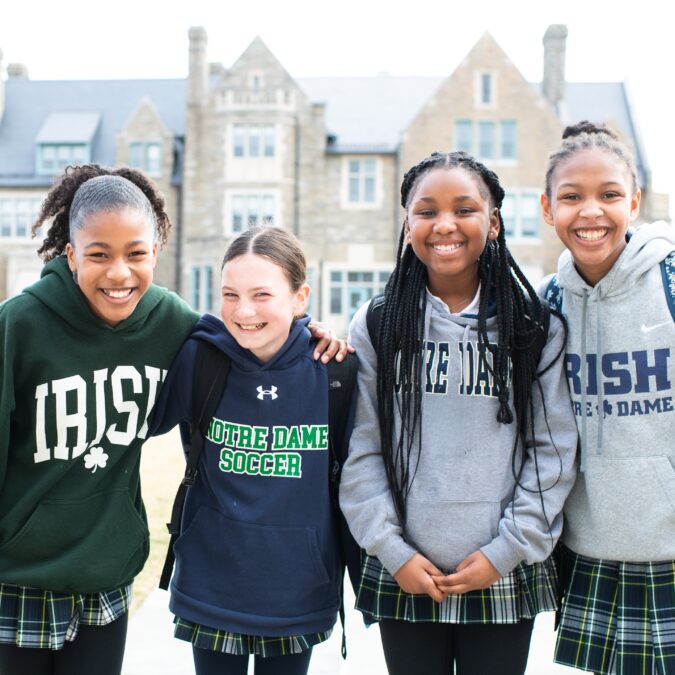 Four students of Academy of Notre Dame posing for the camera on campus