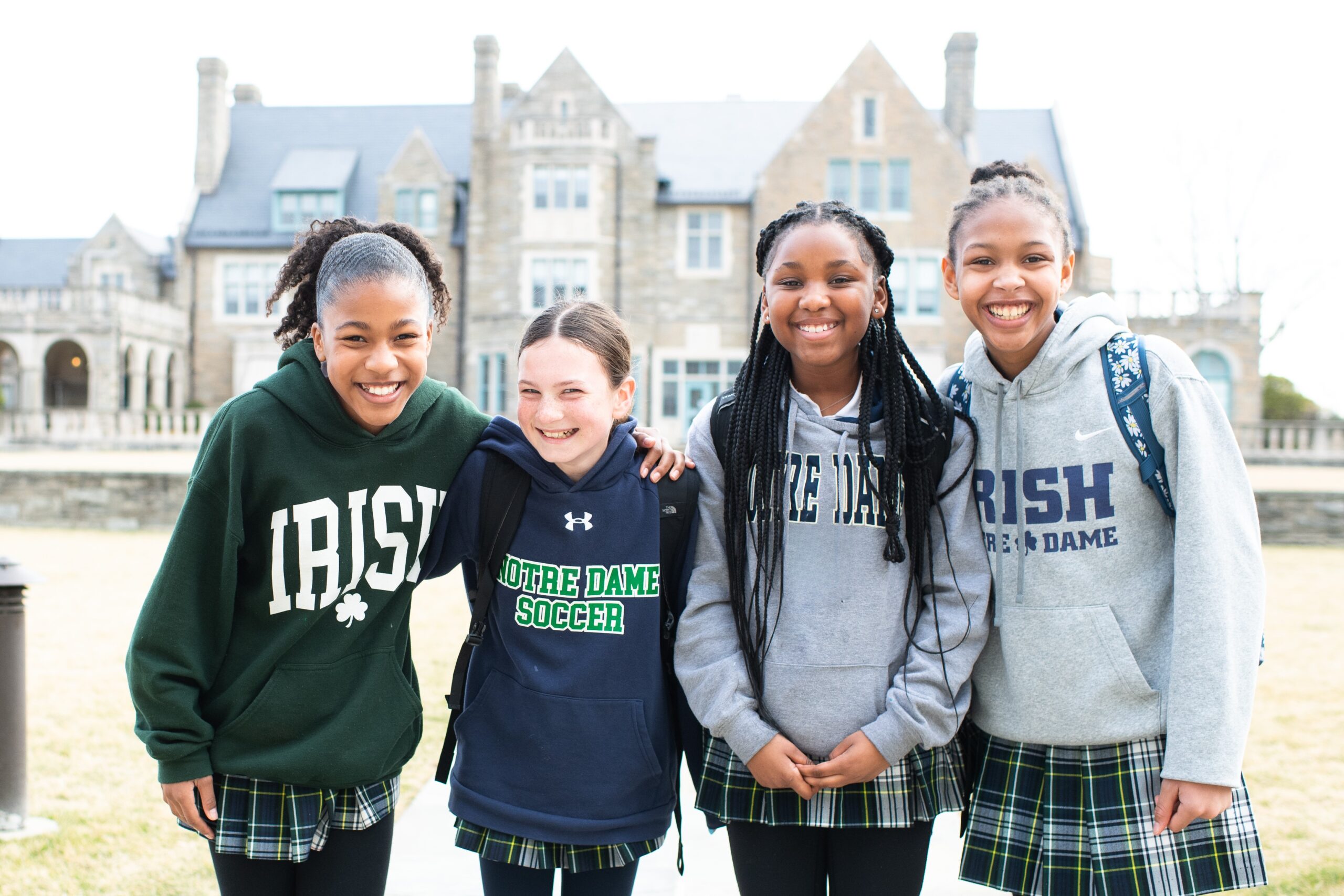 Four students of Academy of Notre Dame posing for the camera on campus
