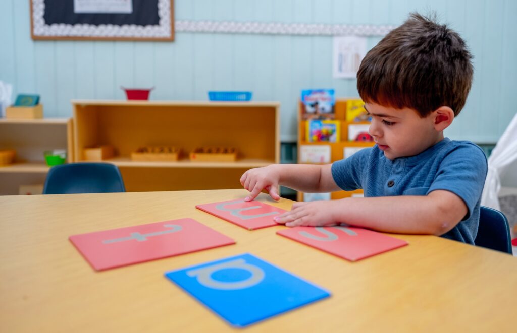 Young male child working on literacy school work