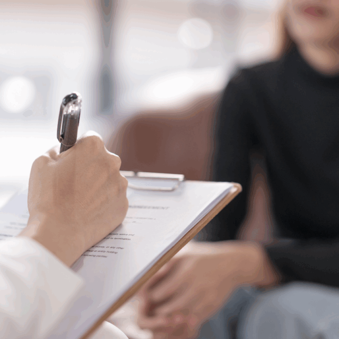 Doctor filling out an intake form with a patient