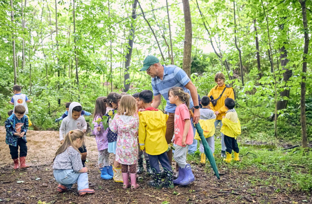 Westtown lower school students learning a lesson in the woods on campus