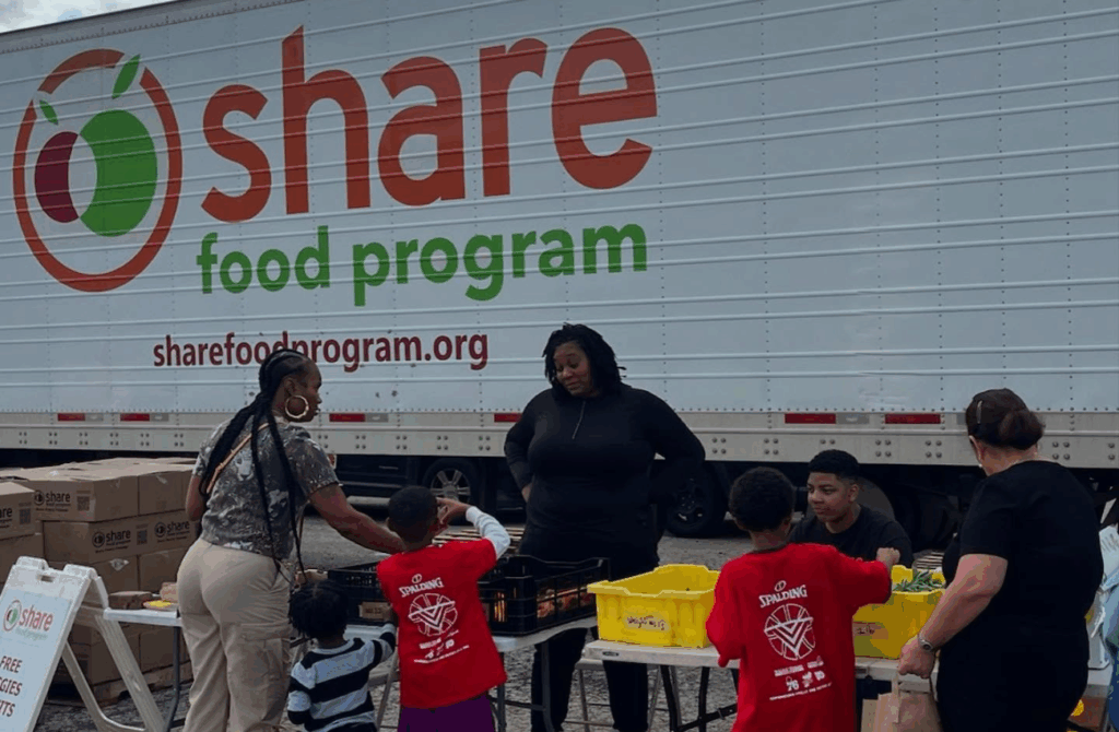 Community members receiving food from a Share Food Program distribution site.