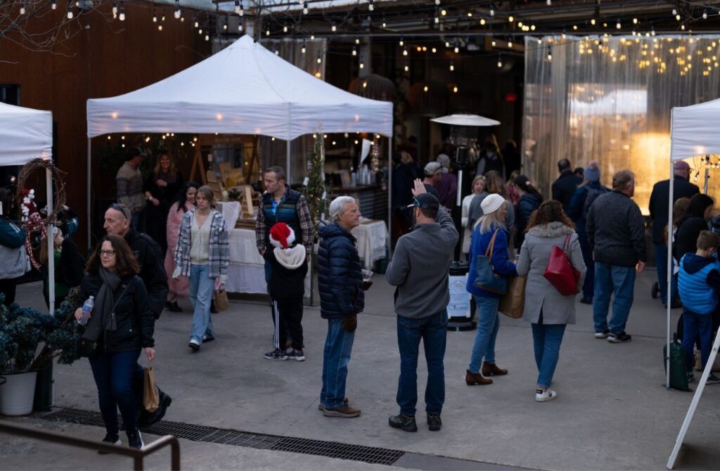 Shoppers enjoying an afternoon at an outdoor holiday market on the Main Line
