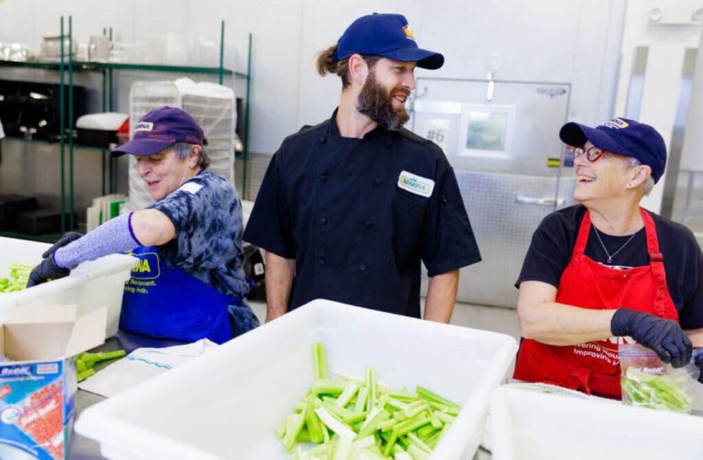 Volunteers help prepare food in the MANNA kitchen for people with serious illnesses in the Philadelphia area.