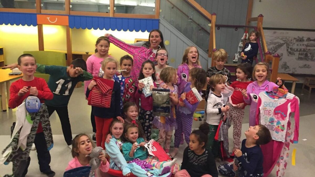 Plaid Pajamas founder Pamela Badolato and a group of children collect pajamas as a way to give back during the holiday season