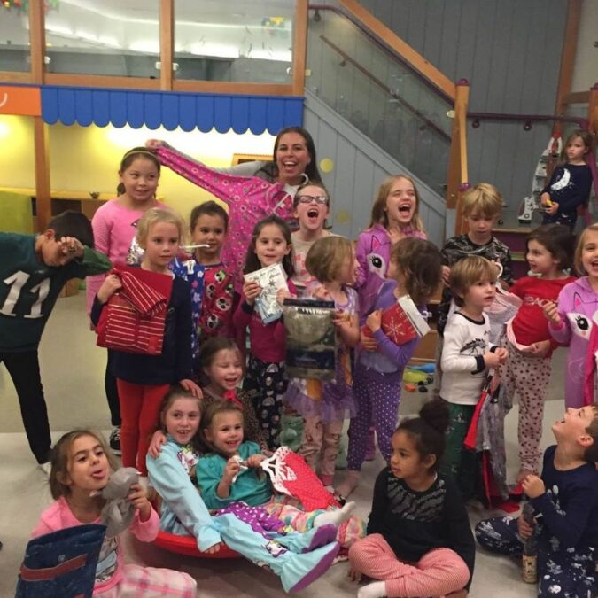Plaid Pajamas founder Pamela Badolato and a group of children collect pajamas as a way to give back during the holiday season