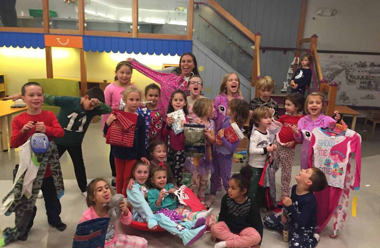 Plaid Pajamas founder Pamela Badolato and a group of children collect pajamas as a way to give back during the holiday season