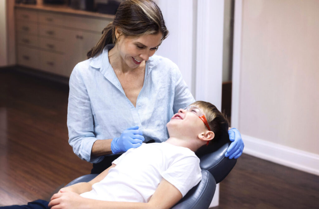 Dr. Catherine Foote performing an orthodontic evaluation on a child.