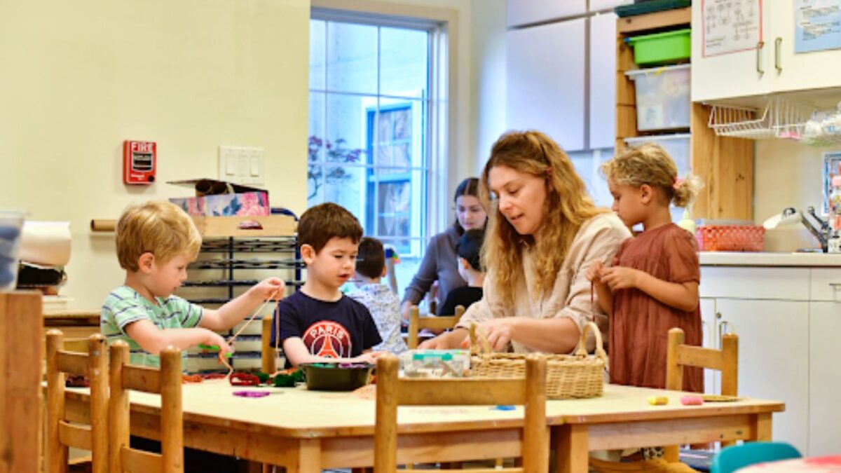 A Phebe Anna Thorne School educator engages a group of preschool children.