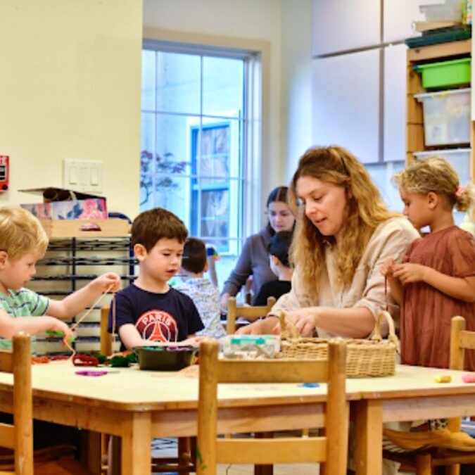 A Phebe Anna Thorne School educator engages a group of preschool children.