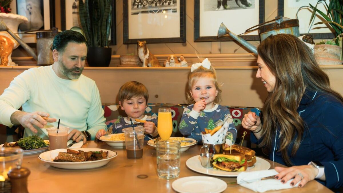 A father, mother and two small childrend enjoy family-friendly dining at the White Dog Cafe in Haverford.