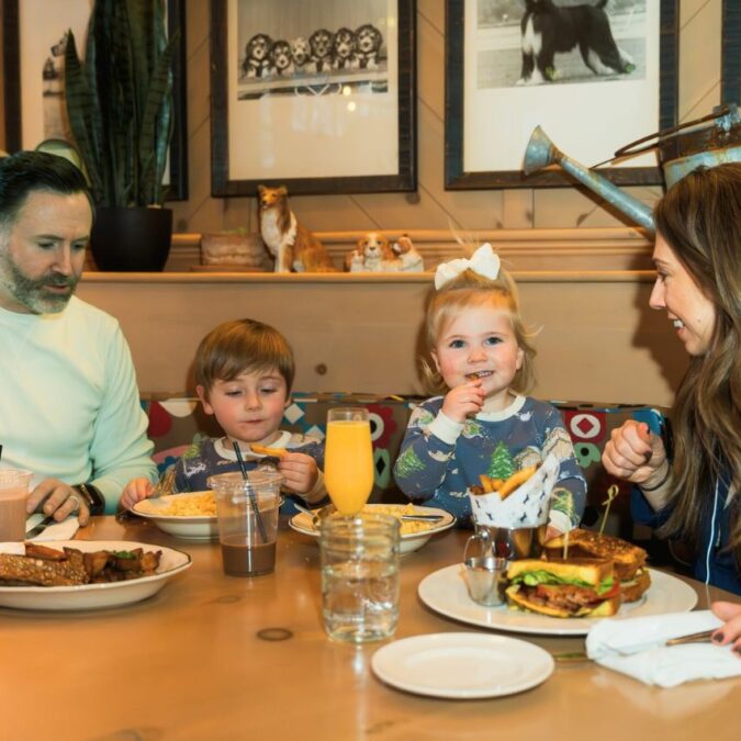 A father, mother and two small childrend enjoy family-friendly dining at the White Dog Cafe in Haverford.