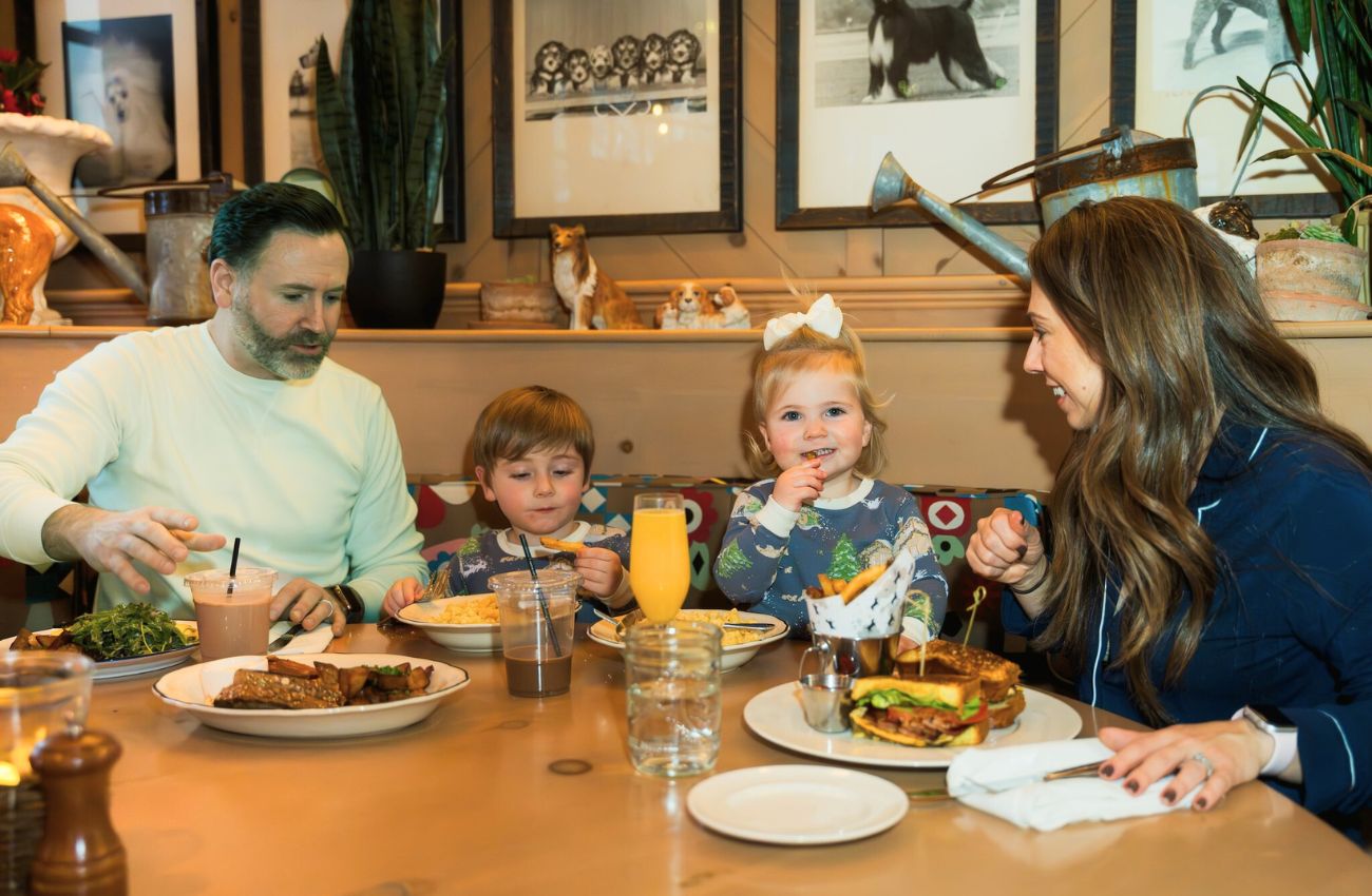 A father, mother and two small childrend enjoy family-friendly dining at the White Dog Cafe in Haverford.