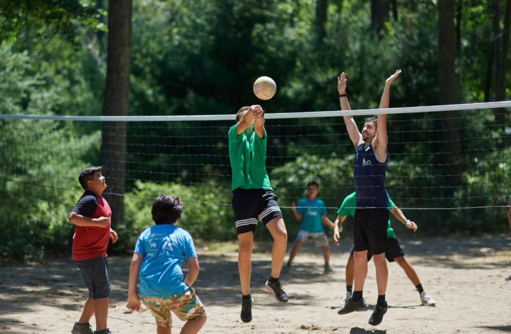 Campers and counselors play volleyball at Camp Speers YMCA.