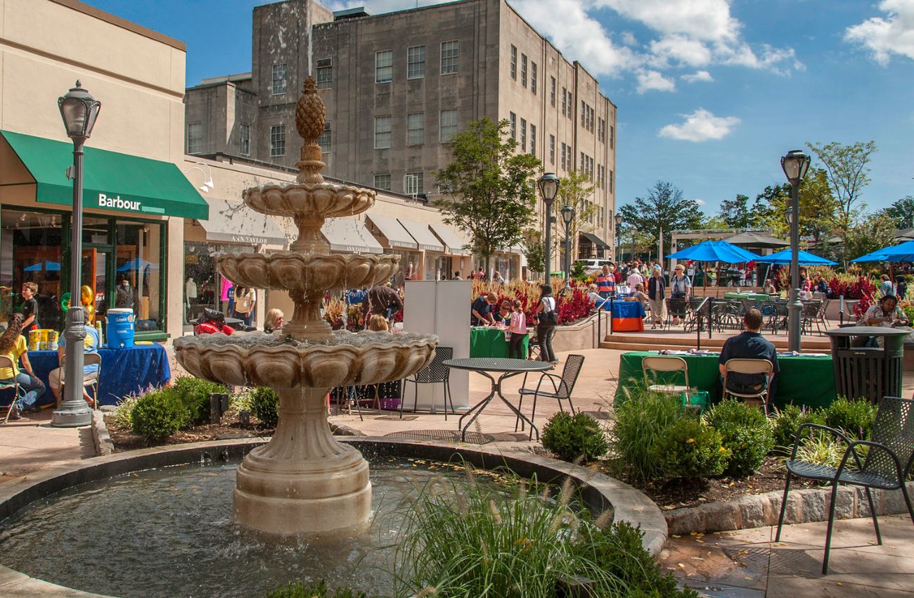 The fountain and cafe tables in Suburban Square on a sunny, warm day in Ardmore, PA.