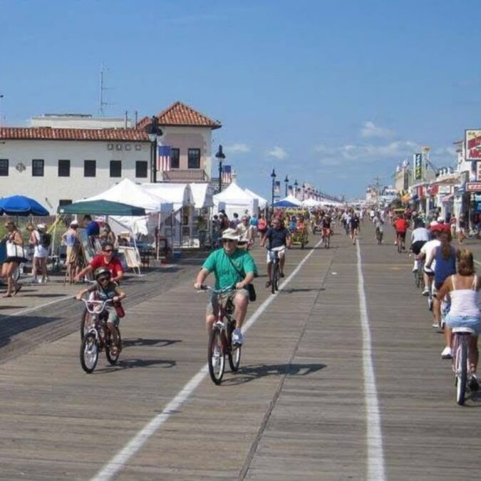 Vacationers ride bikes on the Ocean City, NJ boardwalk in the morning.