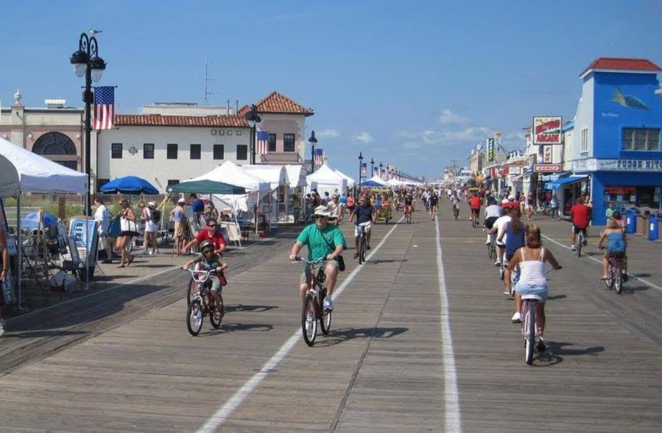 Vacationers ride bikes on the Ocean City, NJ boardwalk in the morning.