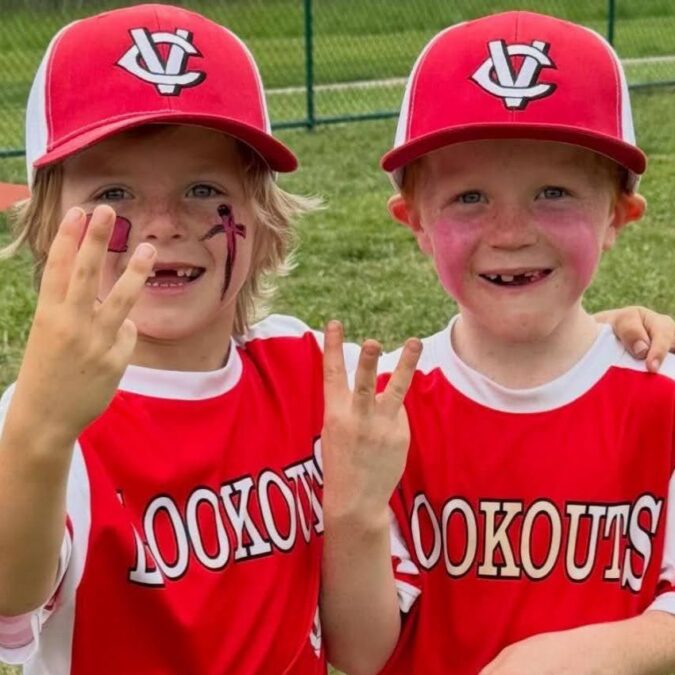 Two little boys wear red Chester County Little League uniforms as part of fall sports for preschoolers on the Main Line.