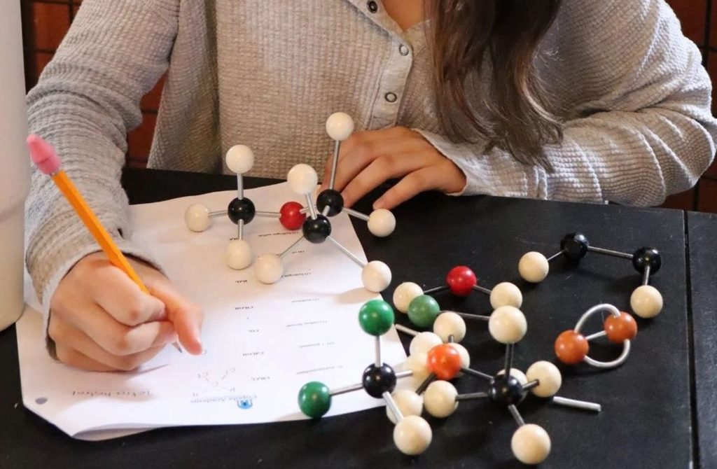 A homeschool student uses a hands-on model at Cupola Academy.